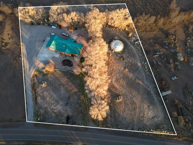 Aerial view of property and surrounding area with property parcel outlined and a pool area