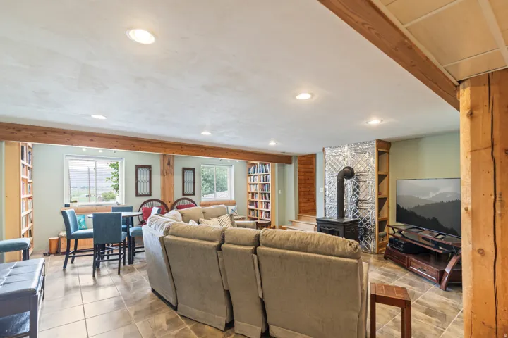 Tiled living area featuring recessed lighting and a wood stove