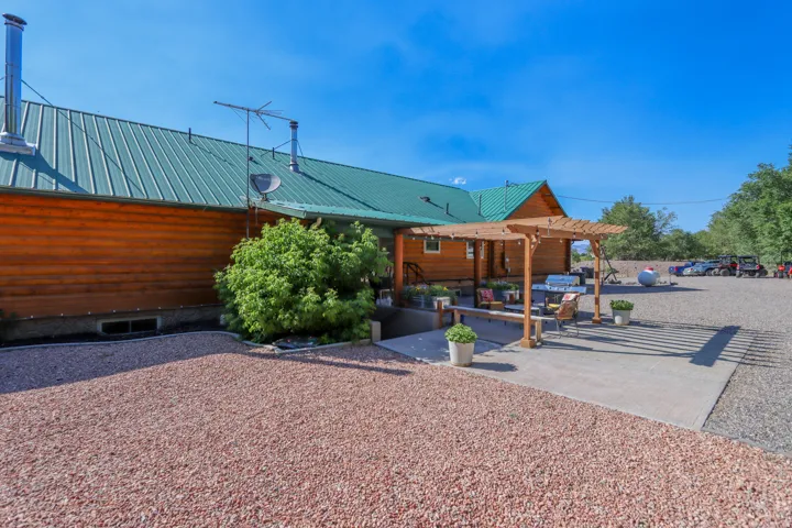 Log-sided exterior with a green metal roof