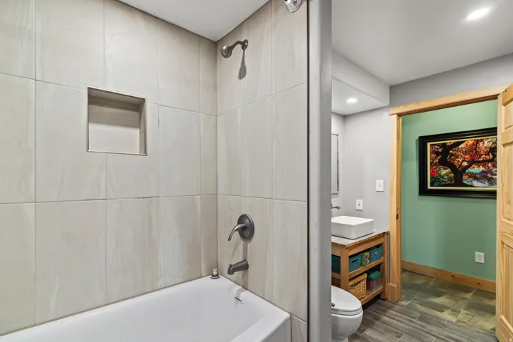 Full bath with vanity, bathing tub / shower combination, recessed lighting, and dark wood-style floors