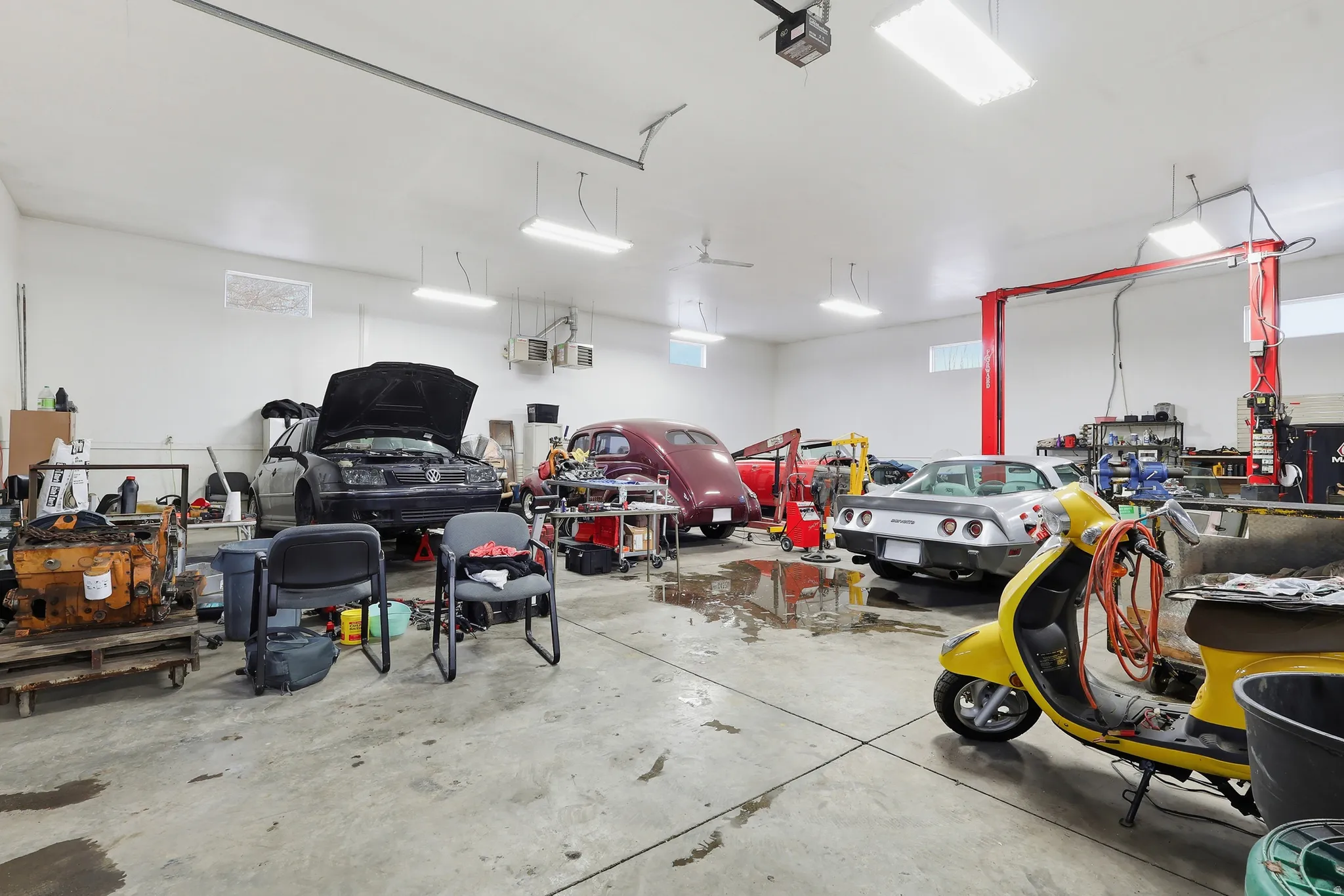 Garage featuring a garage door opener and a heating unit