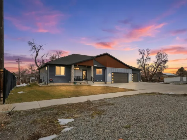 Contemporary home with driveway, board and batten siding, a garage, and covered porch
