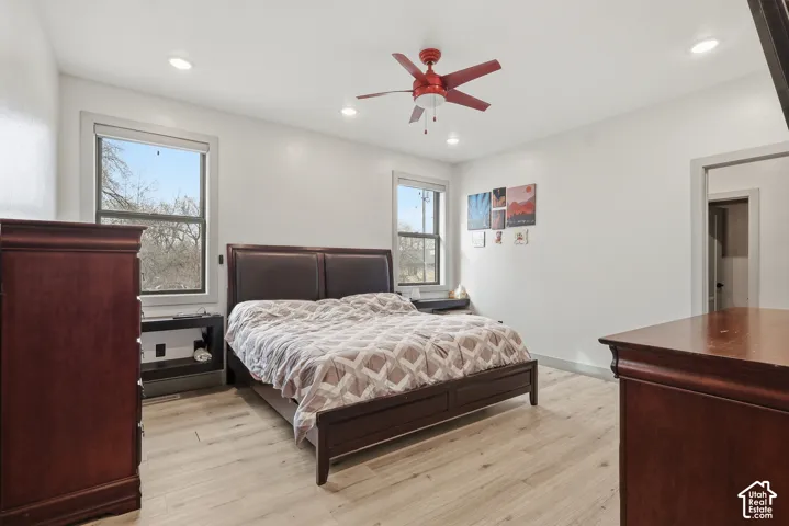 Master Bedroom with light wood-type flooring, ceiling fan, and recessed lighting