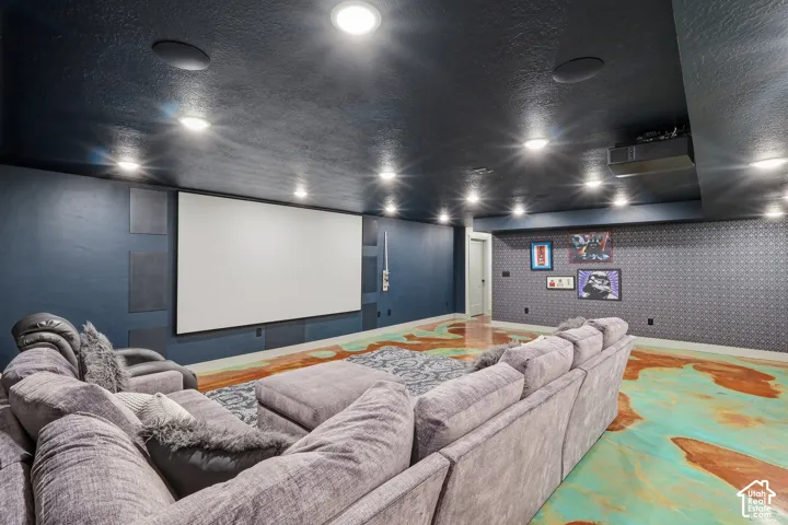 Home theater with a textured ceiling and recessed lighting