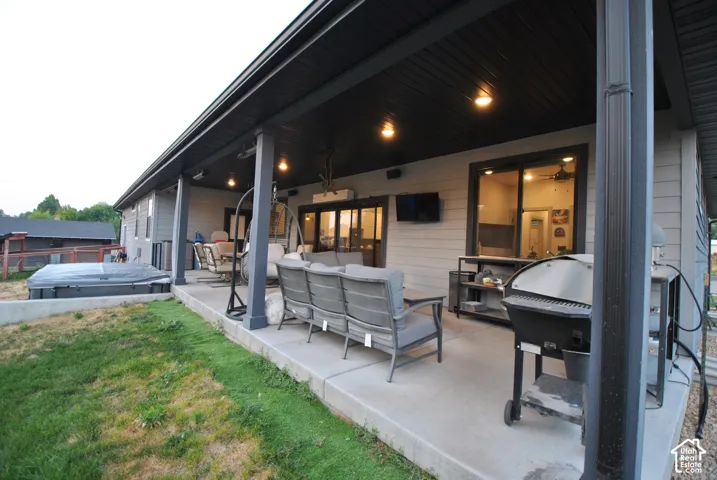 Expansive covered patio featuring recessed lighting, a built-in outdoor speaker, and concrete flooring