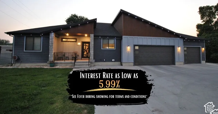 Front of the home featuring the 3 (put 4 car stall) car garage, custom metal siding, beautiful front solid door and so much more.   Rate buy down is based off of a quote given by David Allen GreenLight Lending.
