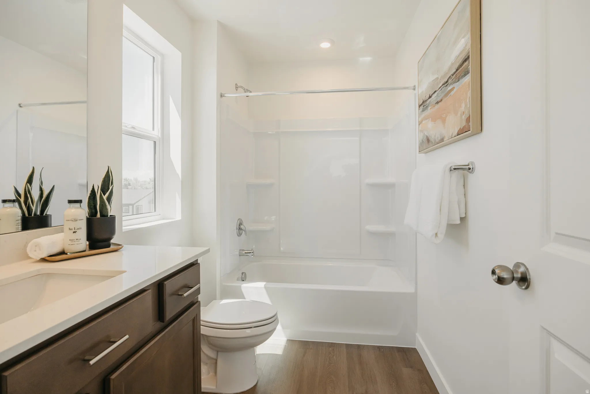 Full bath with vanity, bathing tub / shower combination, and light wood-type flooring