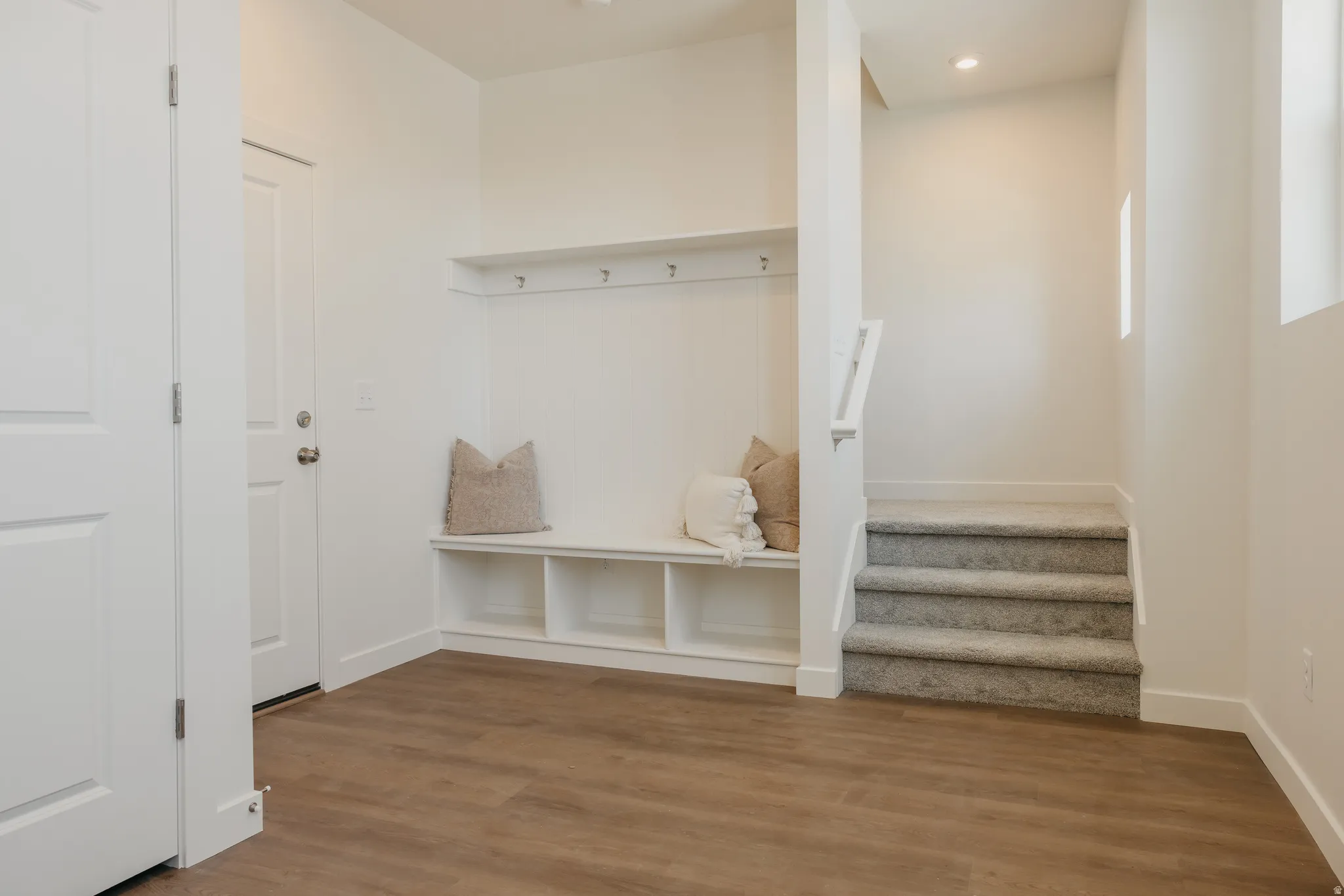 Mudroom with wood finished floors and recessed lighting