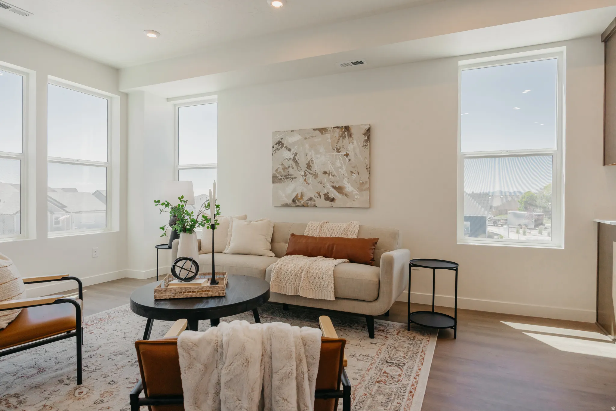 Living area with wood finished floors and recessed lighting