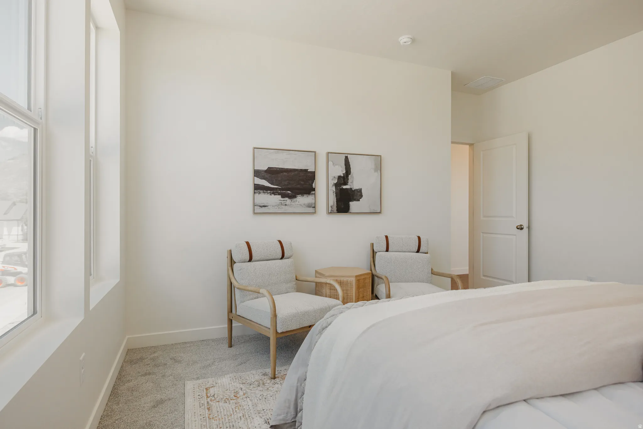 Carpeted bedroom featuring multiple windows