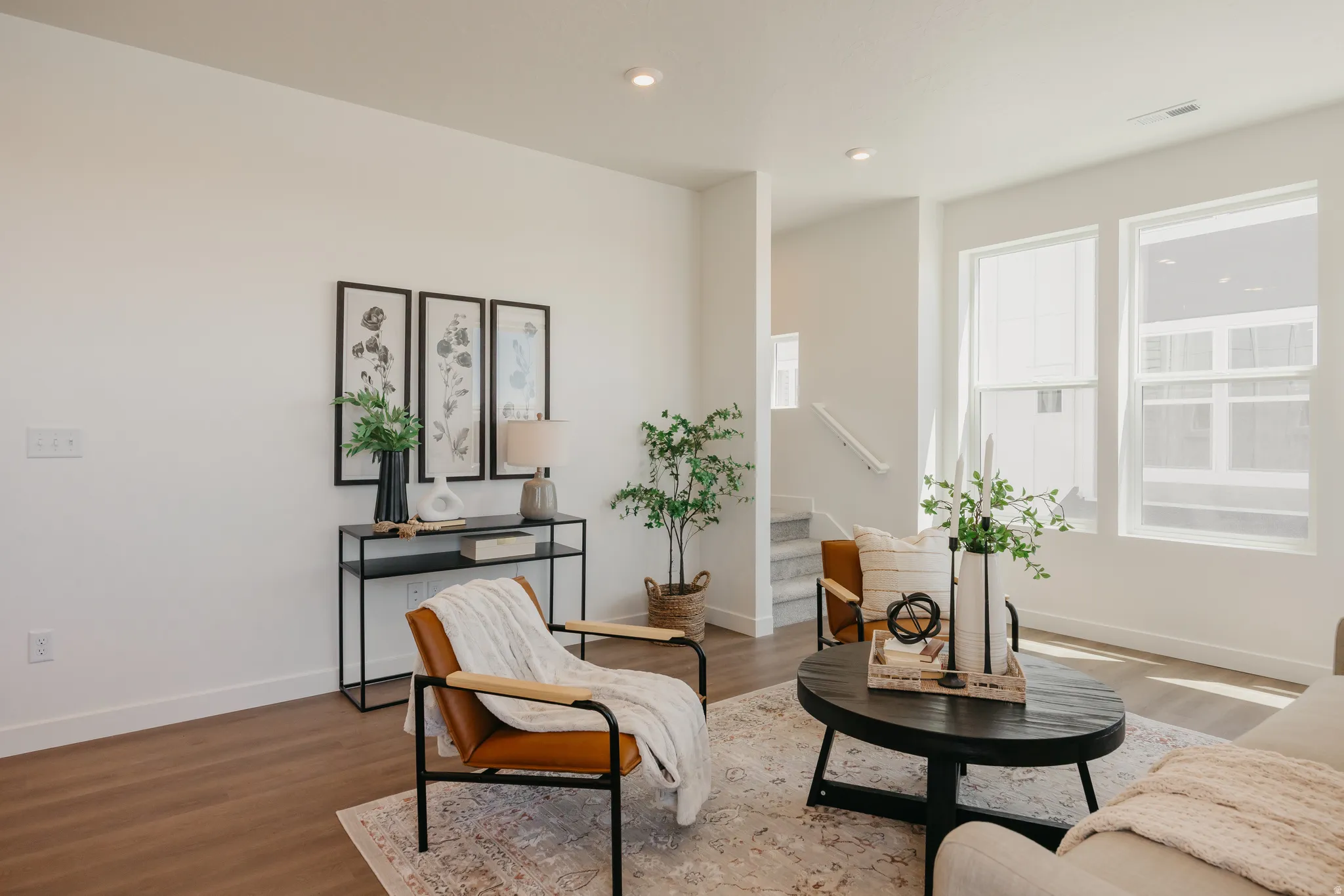 Sitting room with wood finished floors and recessed lighting
