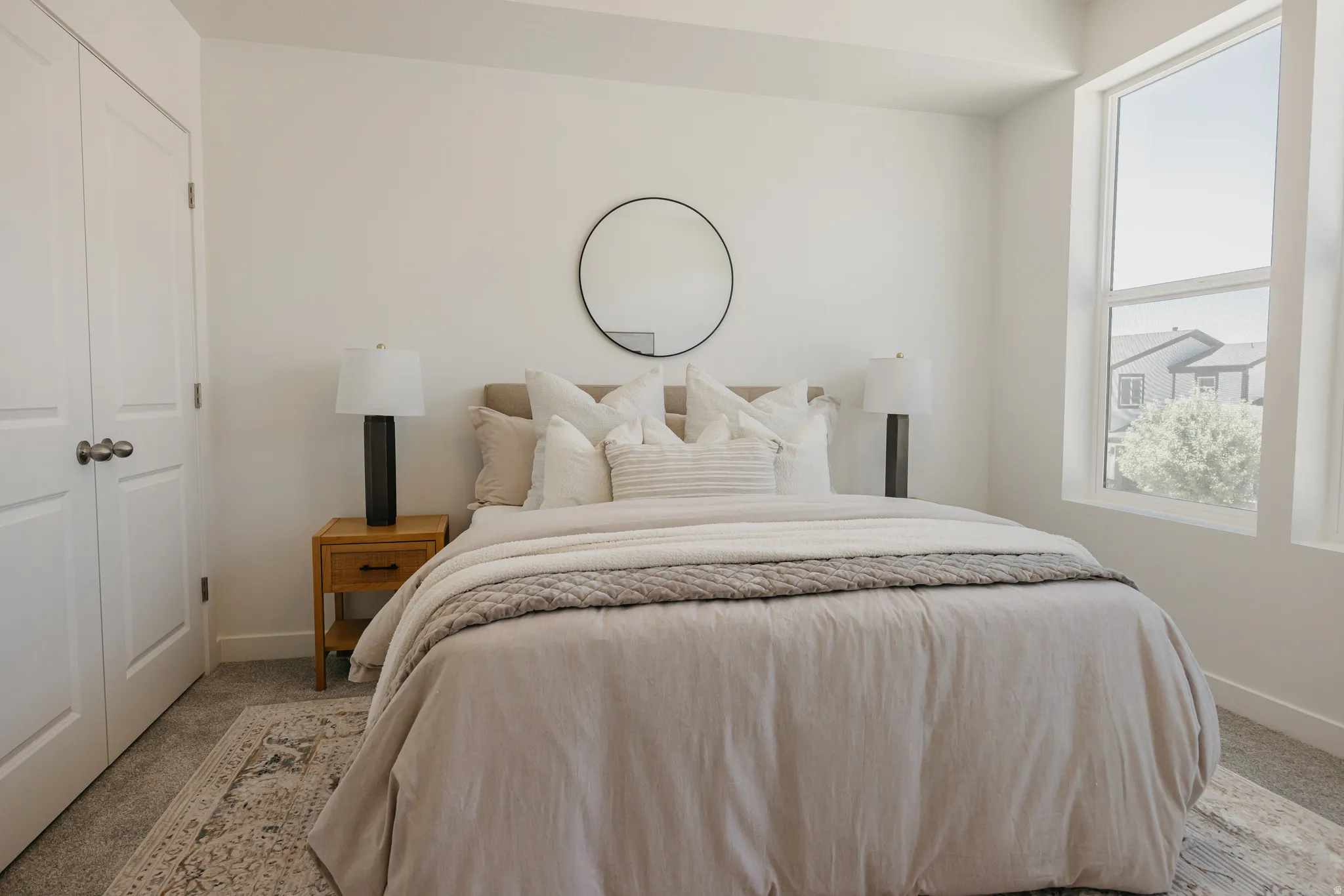 Carpeted bedroom with a closet and baseboards