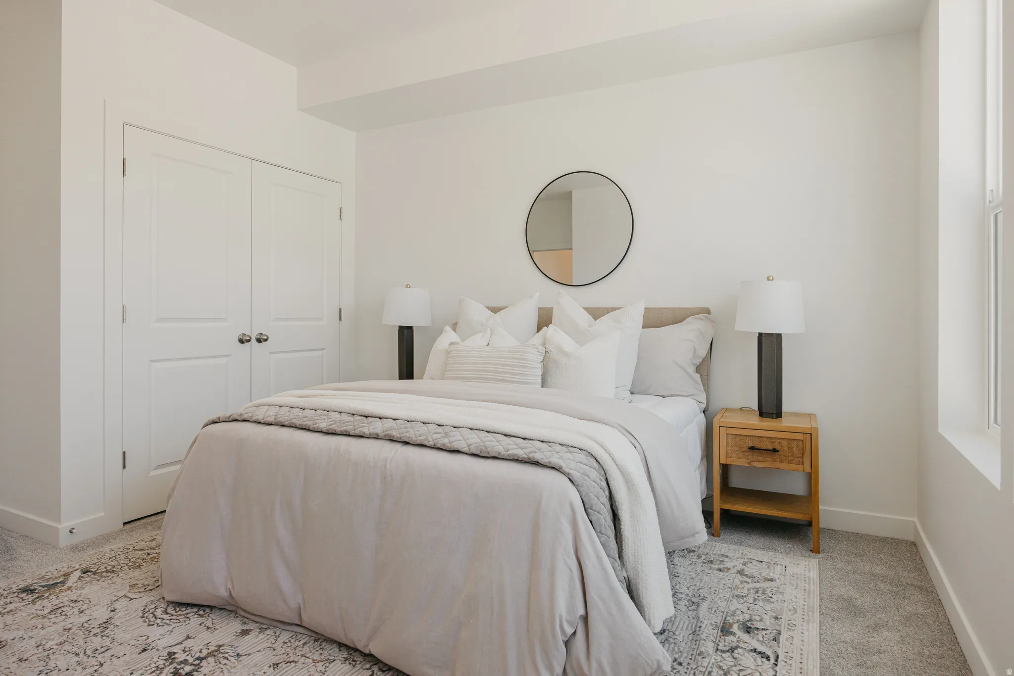 Carpeted bedroom with baseboards and a closet