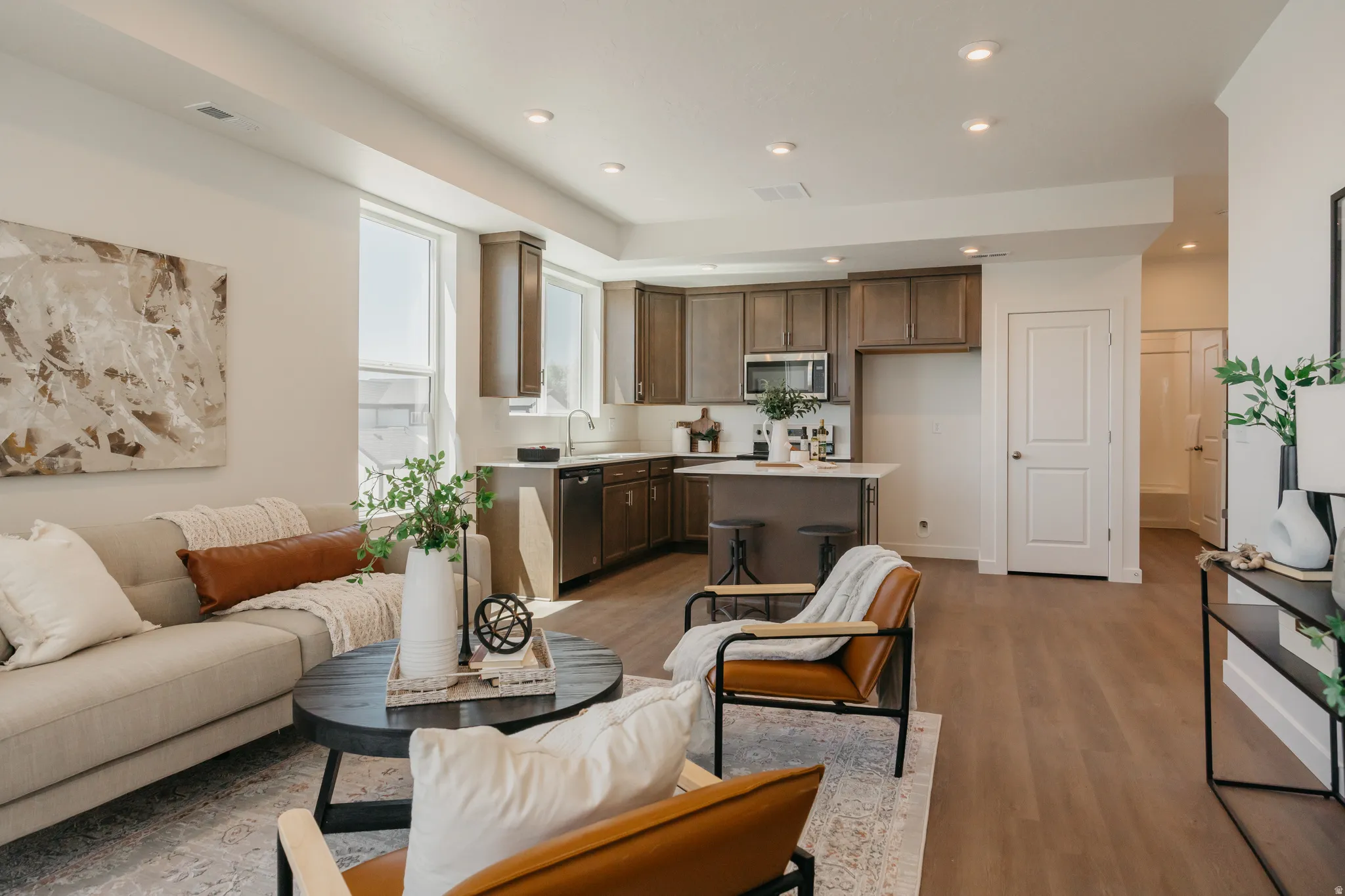 Living area featuring light wood finished floors and recessed lighting