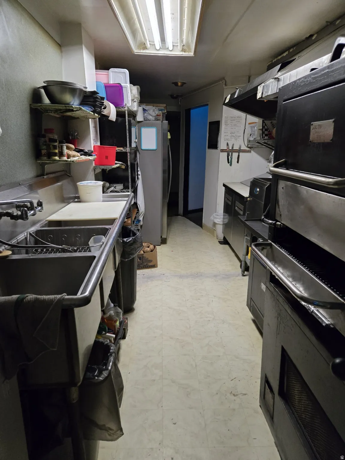 Kitchen with stainless steel refrigerator and light countertops