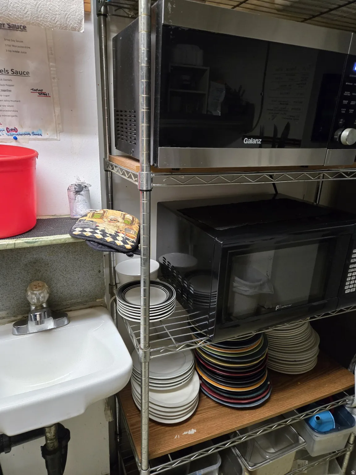 Kitchen view of stainless steel microwave and black microwave