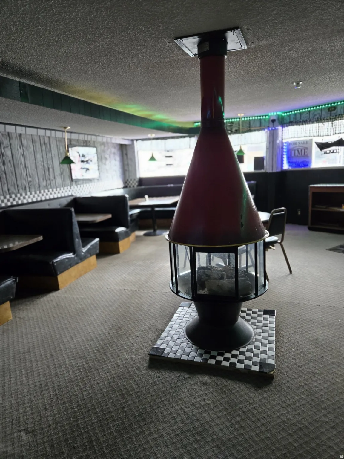 Recreation room with a wood stove and a textured ceiling