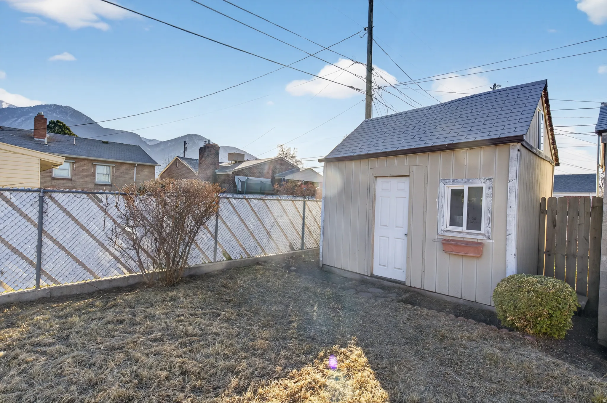 Fenced backyard with a storage shed
