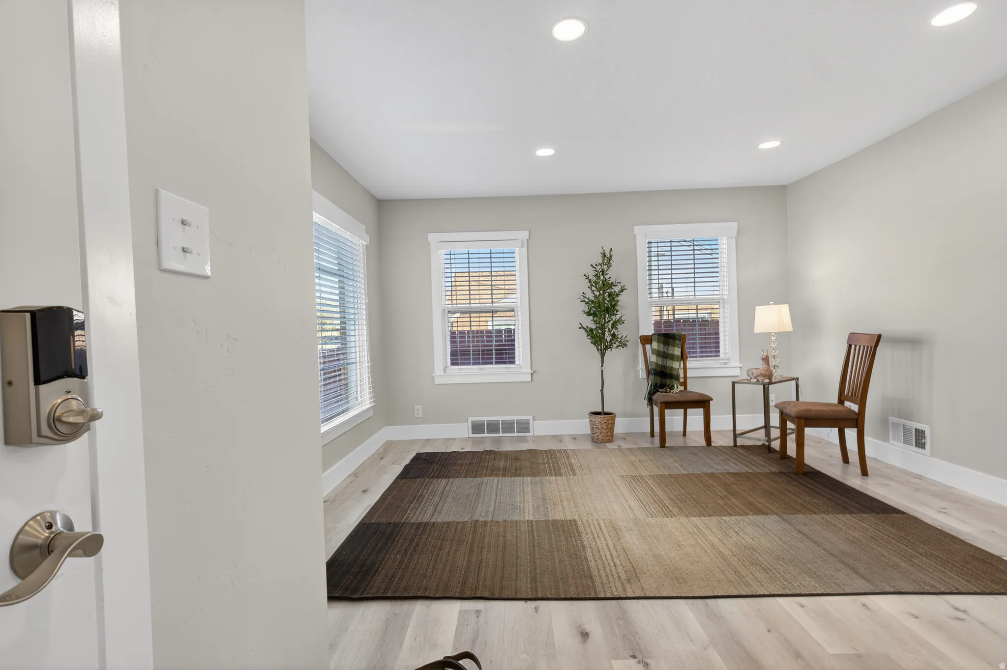 Living area featuring light wood-style floors and recessed lighting