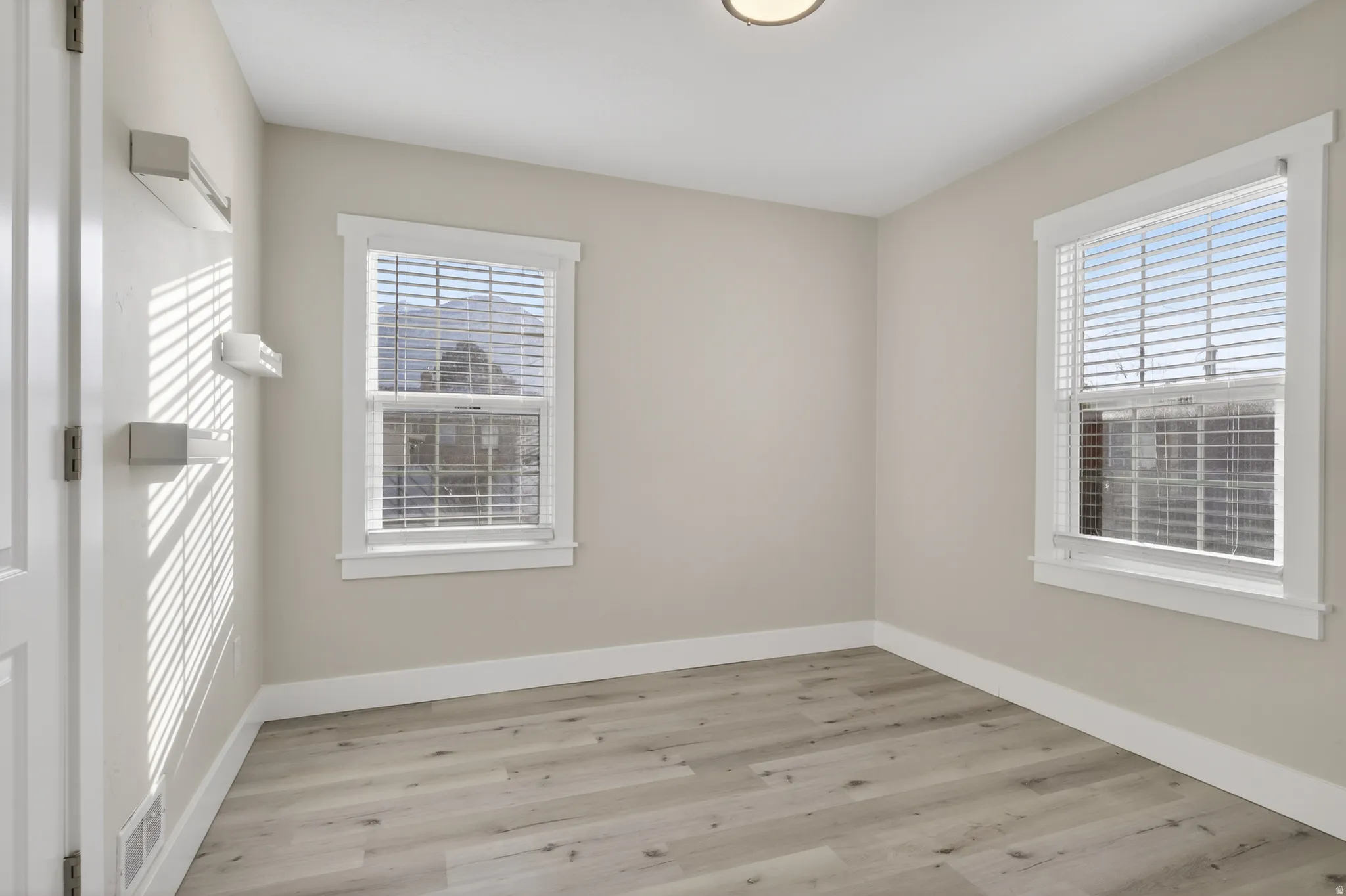 Unfurnished room featuring light wood-style floors and plenty of natural light