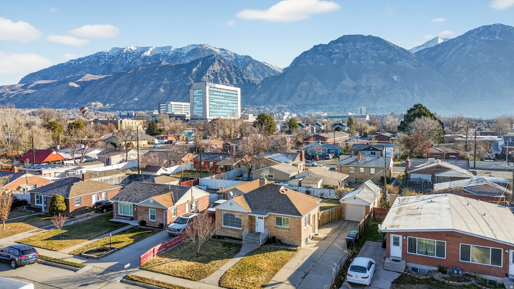 Aerial perspective of suburban area featuring a mountain backdrop