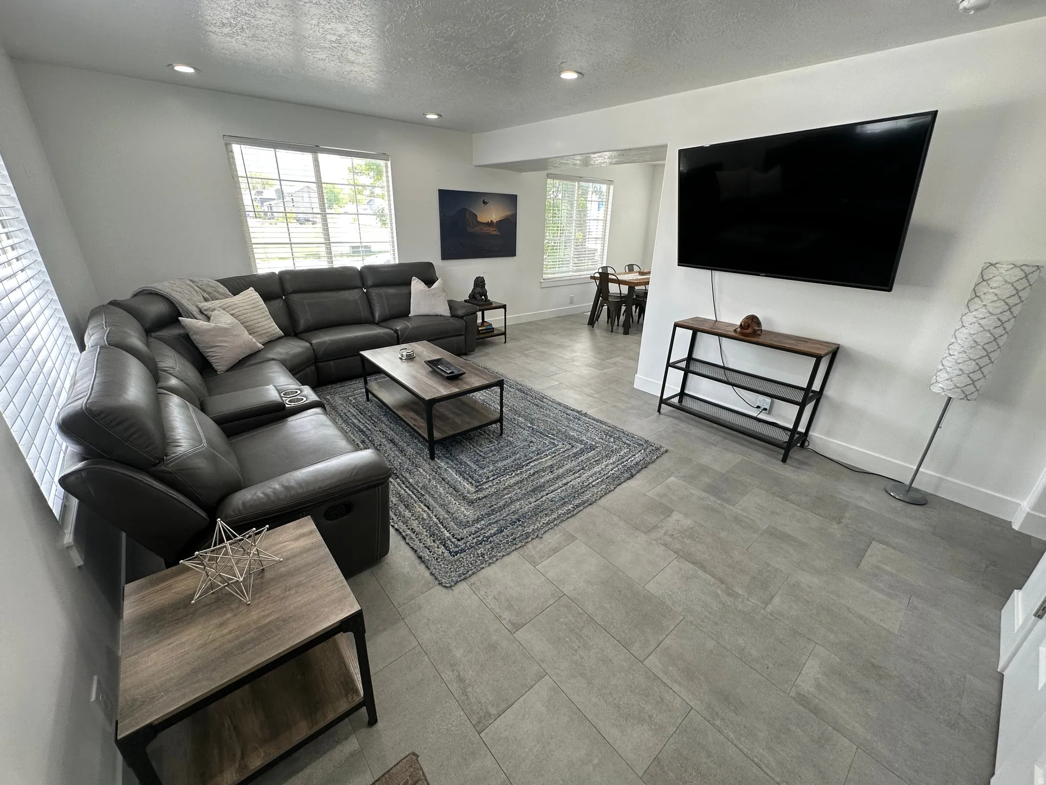 Living room featuring a textured ceiling and recessed lighting