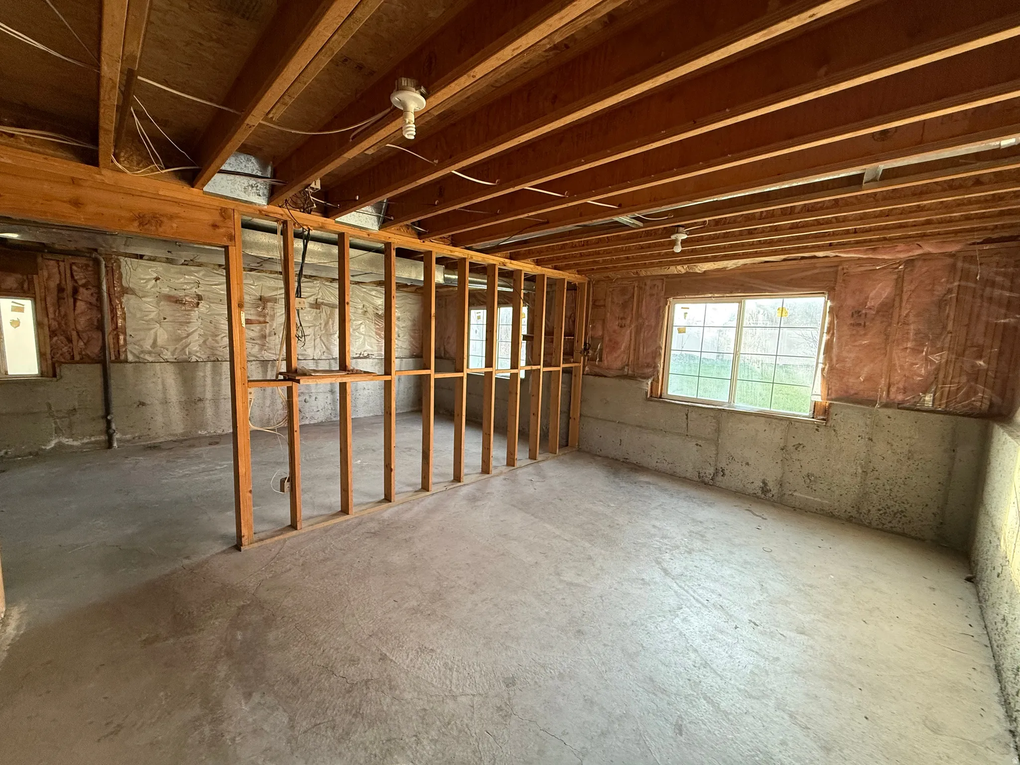 Miscellaneous room featuring unfinished concrete flooring