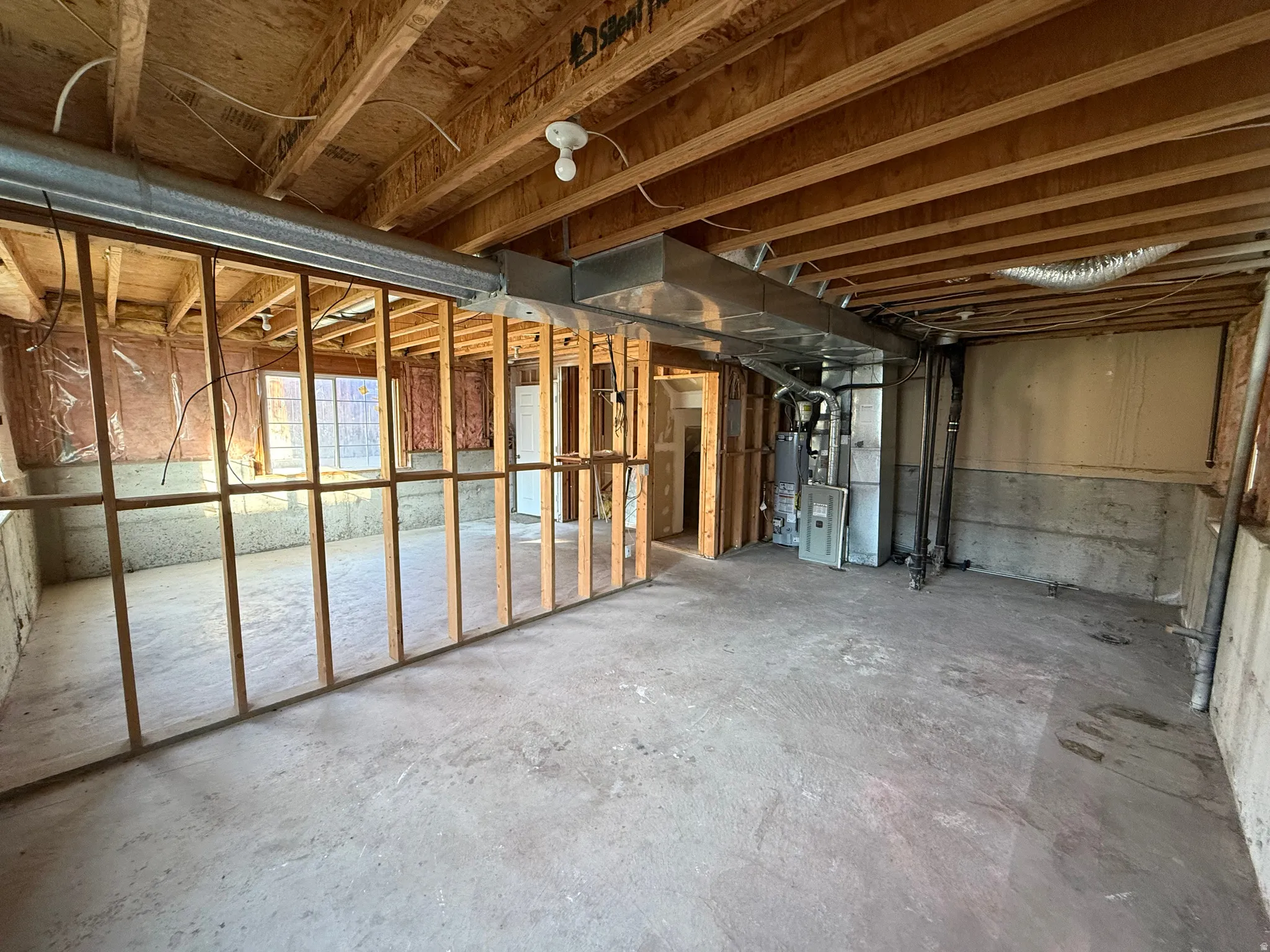 Unfinished below grade area with heating unit and water heater