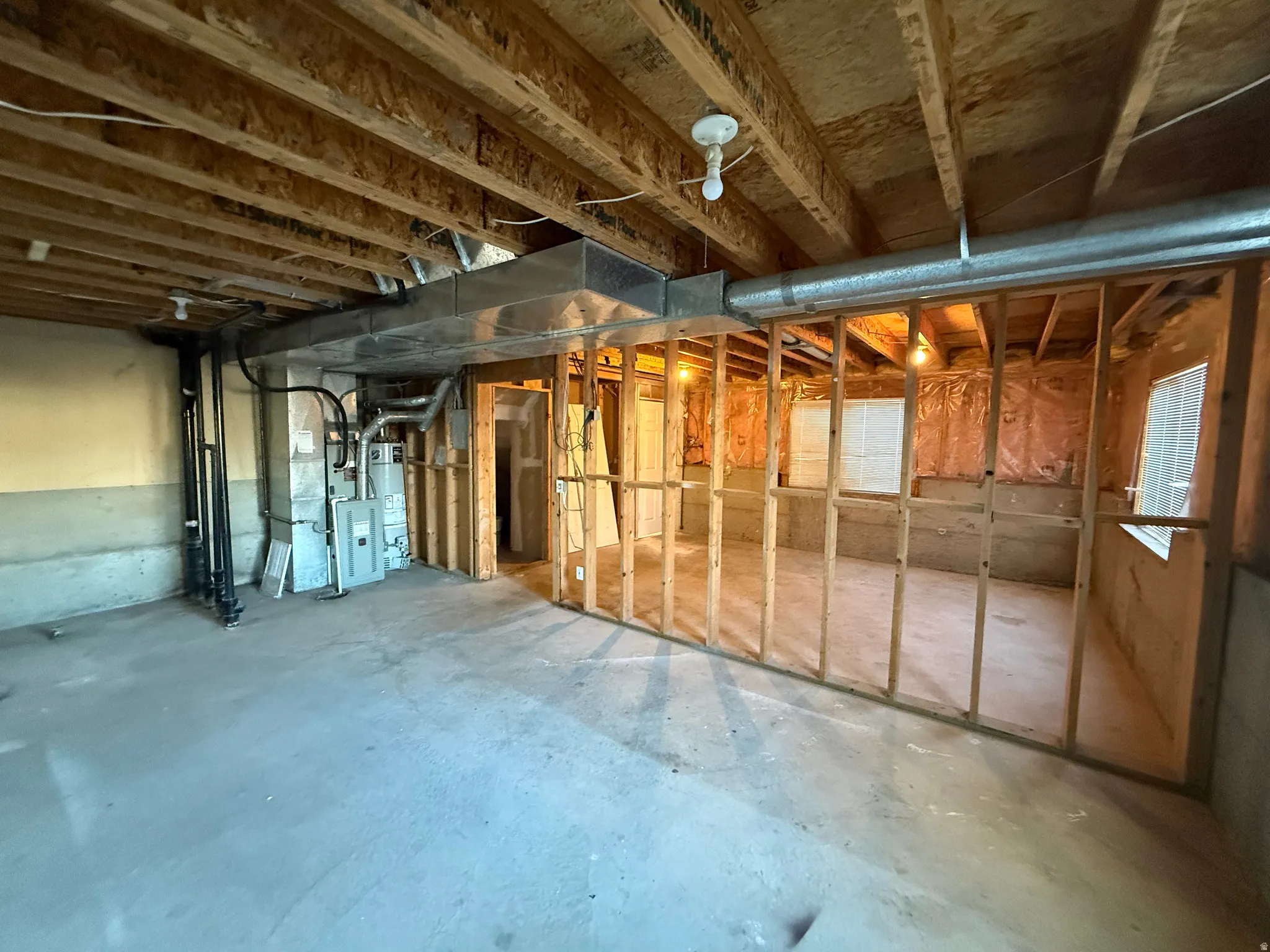 Unfinished basement with water heater and heating unit