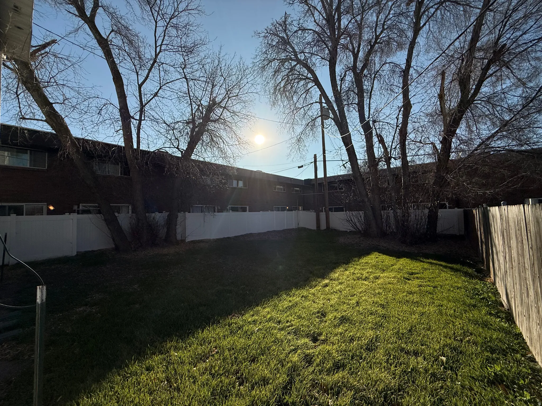 Yard at dusk featuring a fenced backyard