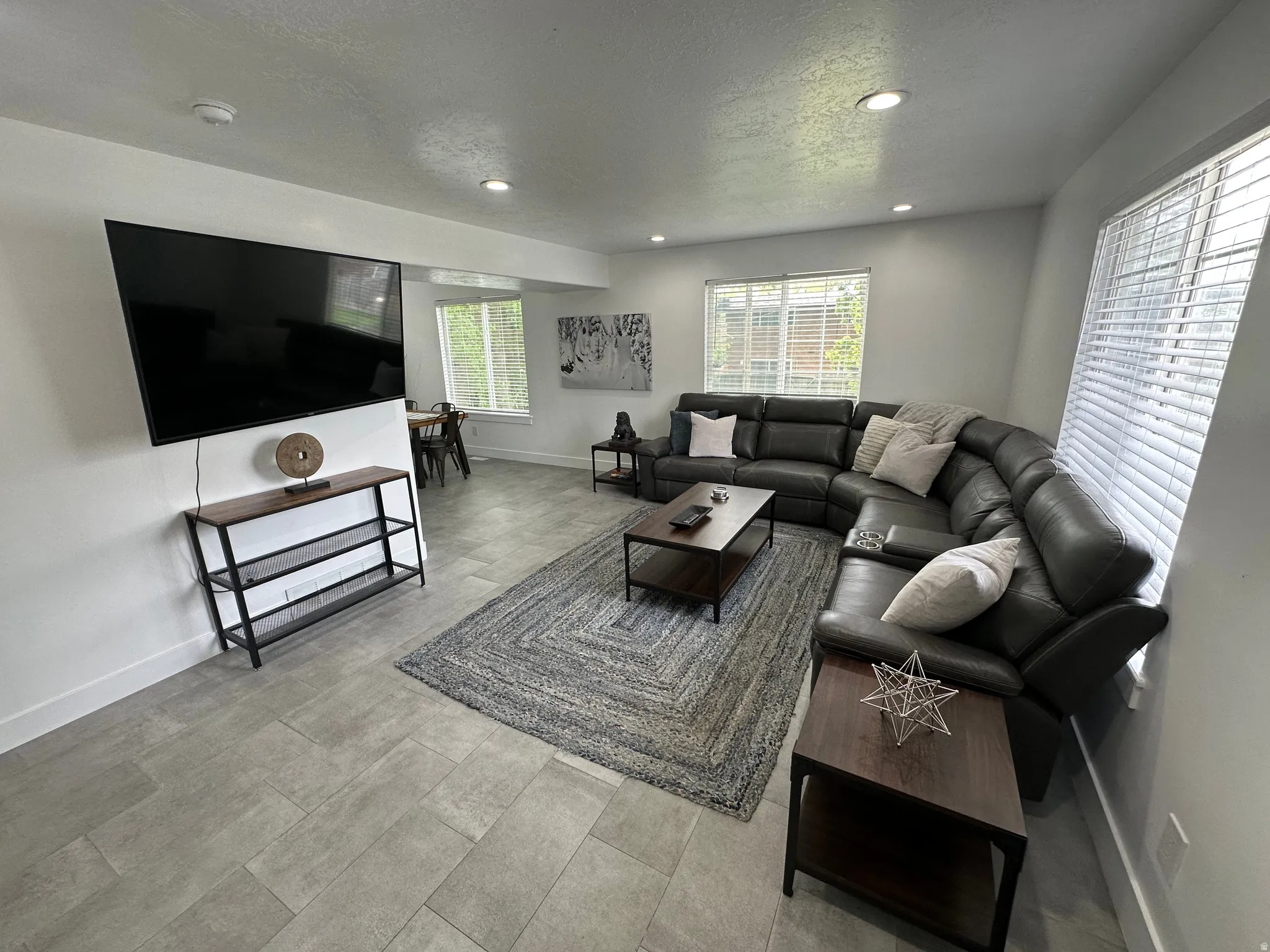 Living room featuring a textured ceiling and recessed lighting