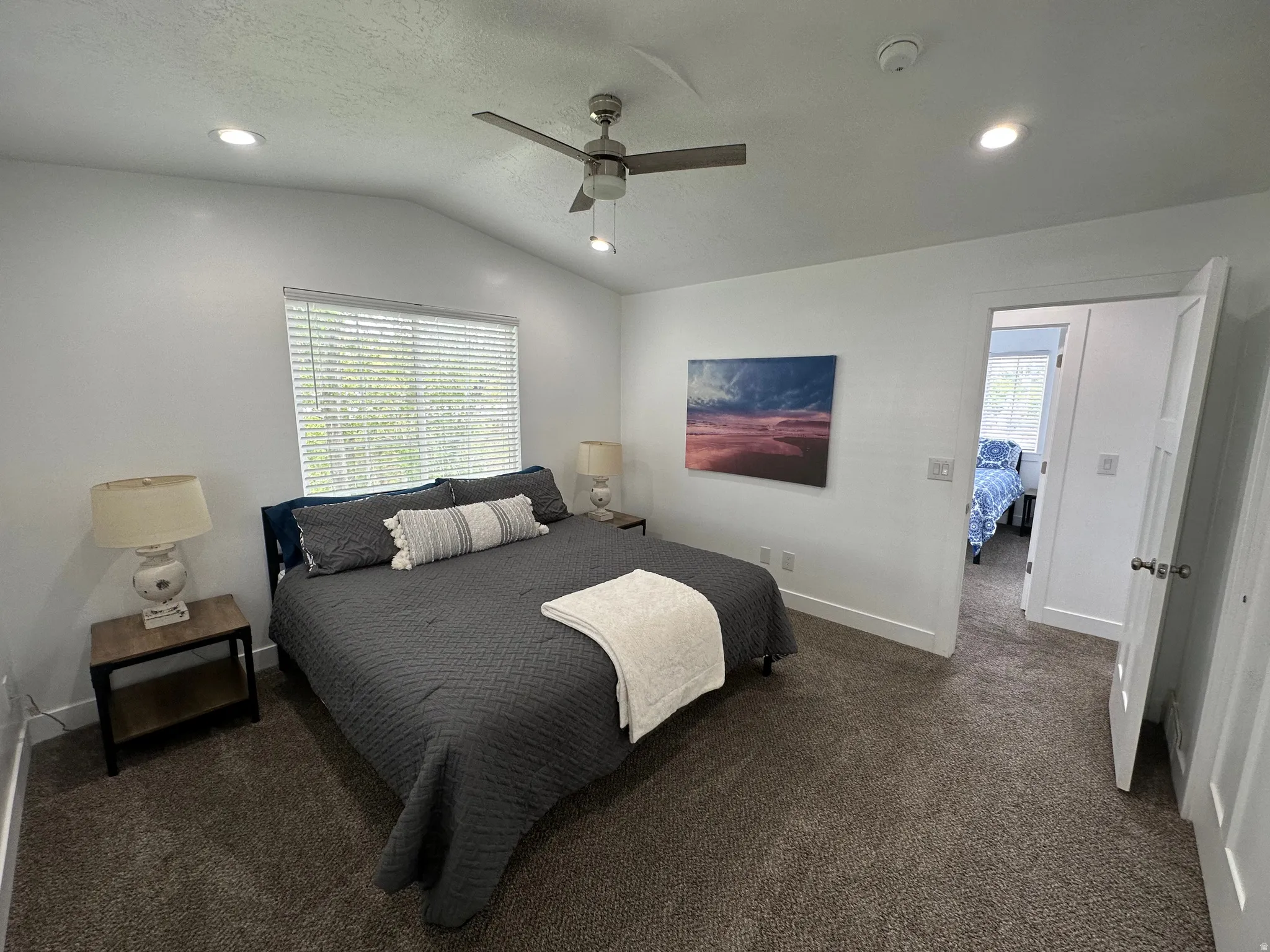 Bedroom featuring ceiling fan, recessed lighting, vaulted ceiling, and dark carpet