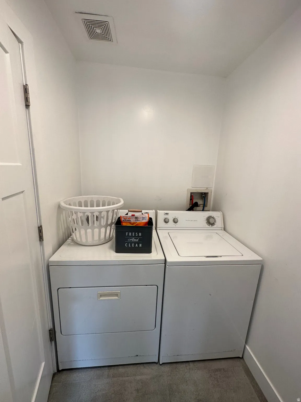 Laundry area featuring washer and dryer and baseboards