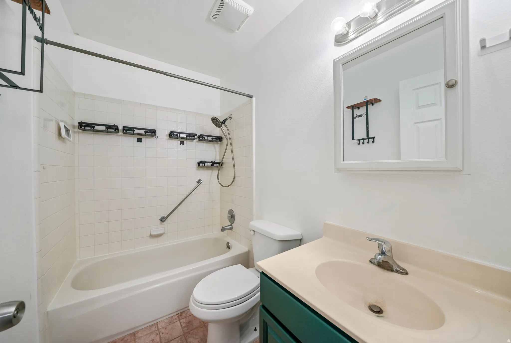 Bathroom with vanity and bathing tub / shower combination