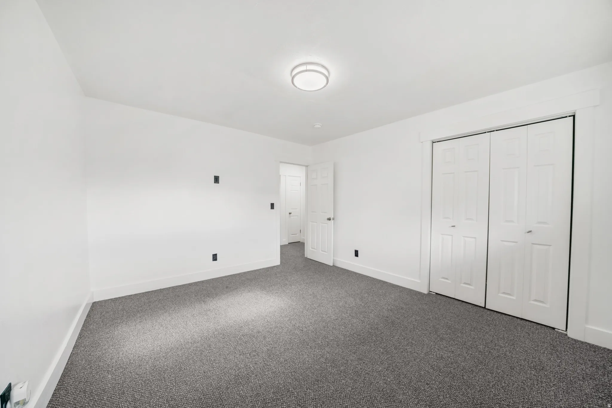 Unfurnished bedroom featuring carpet flooring and a closet