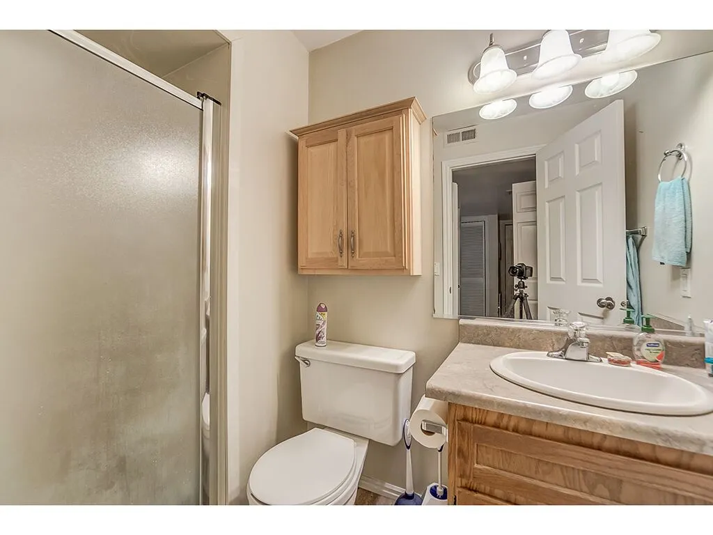 Full bathroom featuring a shower stall and vanity