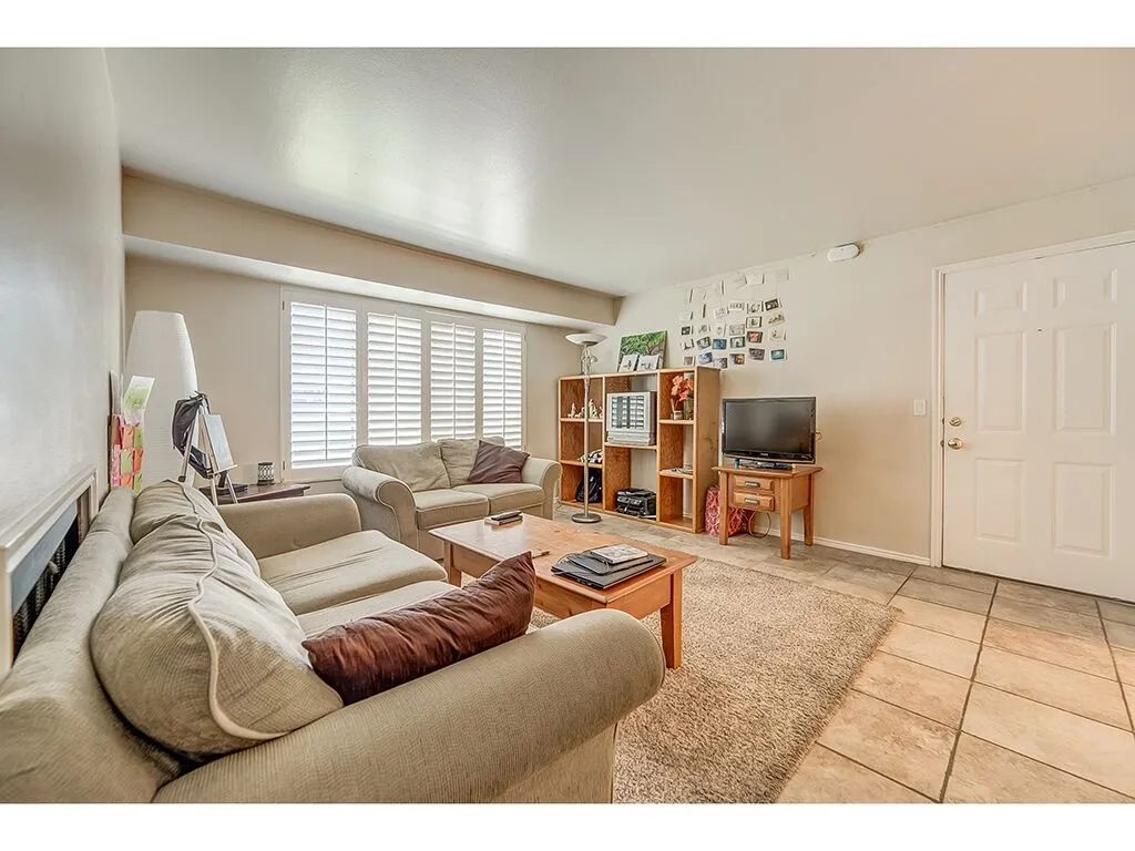 Living room featuring light tile patterned floors and baseboards