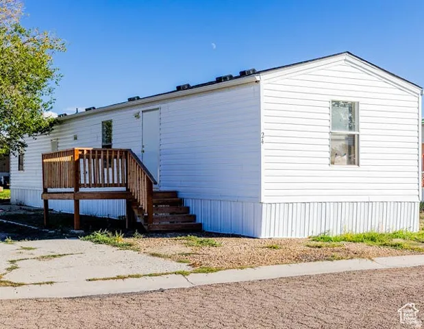 Rear view of house with a wooden deck