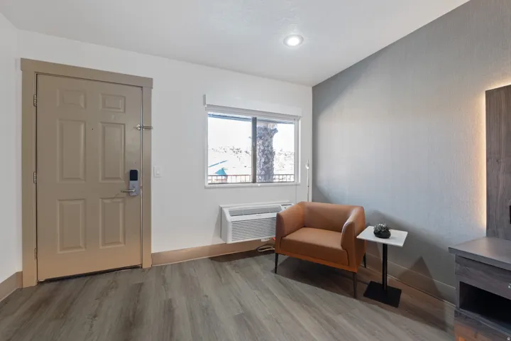 Sitting room featuring wood finished floors and an AC wall unit