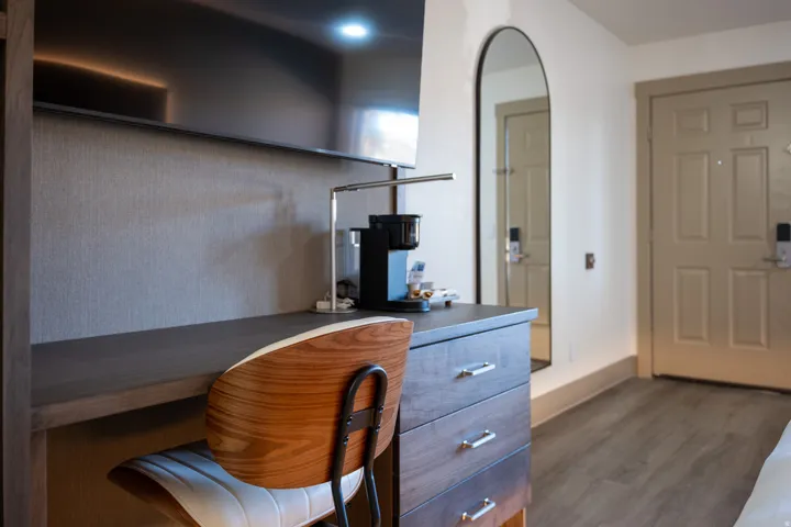 Home office featuring dark wood-type flooring and arched walkways