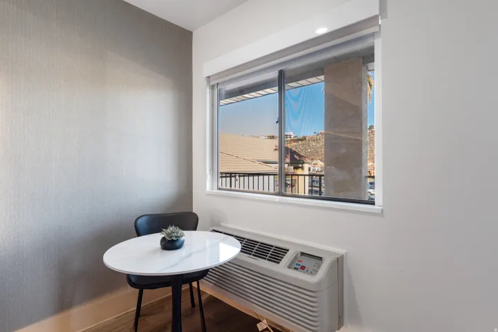 Detailed view of wood finished floors and a wall mounted AC