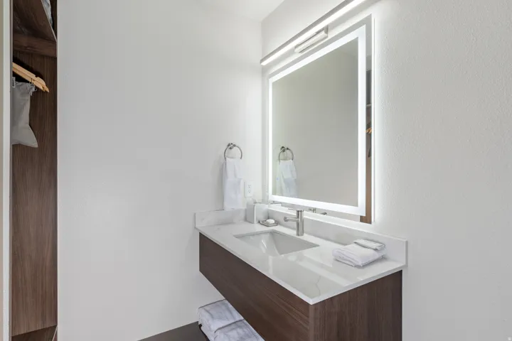 Bathroom with vanity and a textured wall