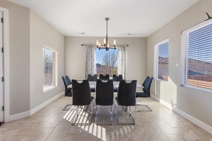 Dining area featuring a chandelier and baseboards