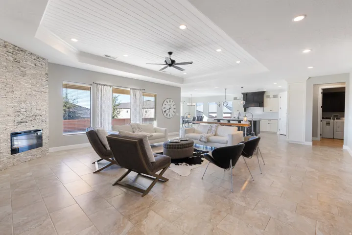 Living area with ceiling fan, healthy amount of natural light, a fireplace, washer and dryer, and recessed lighting