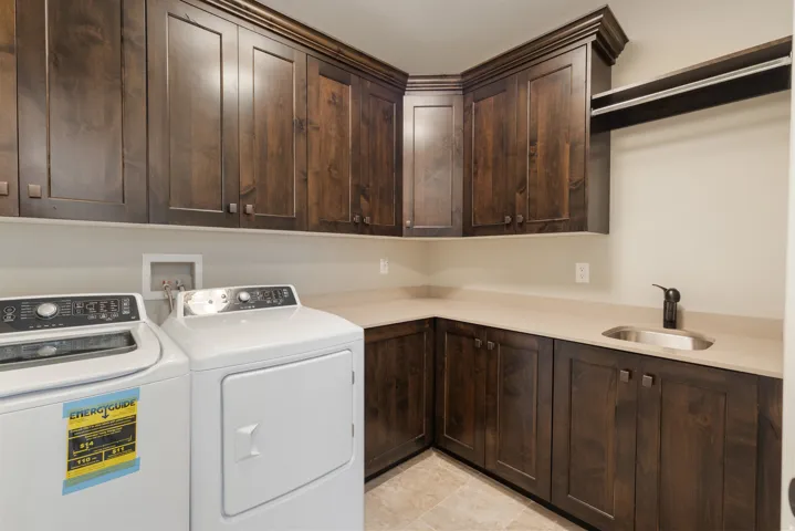 Laundry area with cabinet space and independent washer and dryer