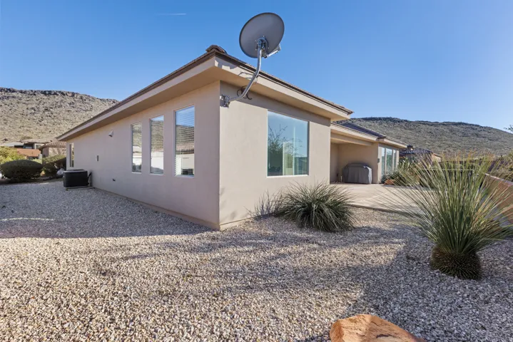 View of home's exterior featuring stucco siding, a patio area, and a mountain view