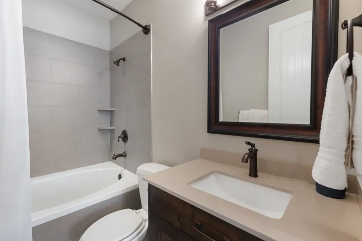 Bathroom with shower / tub combo with curtain and vanity