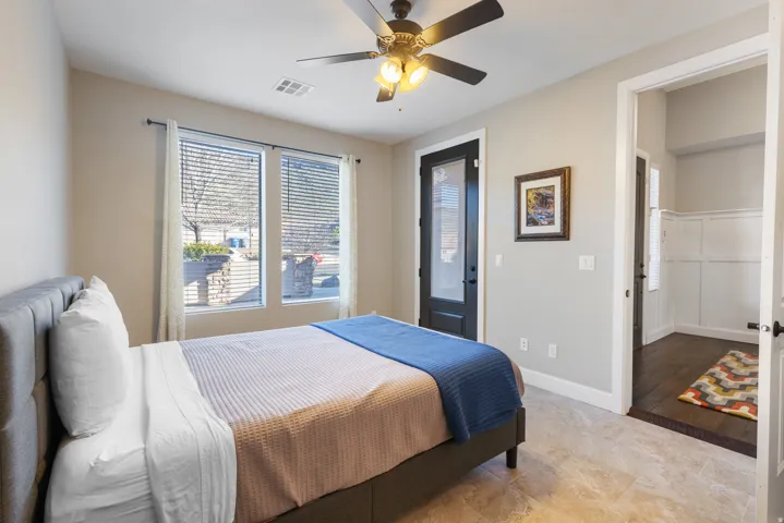 Bedroom with ceiling fan and baseboards