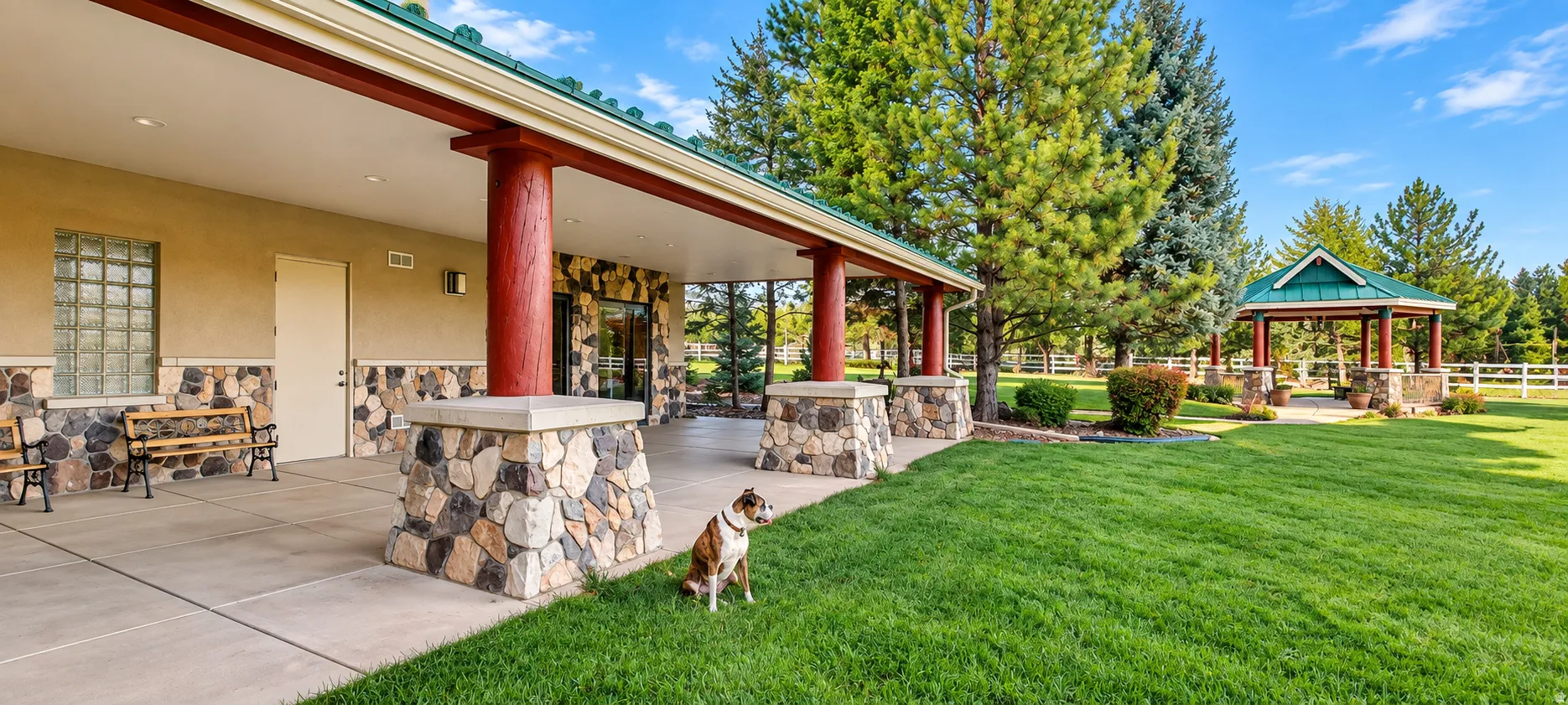 Expansive covered patio with stone-wrapped columns and a concrete surface