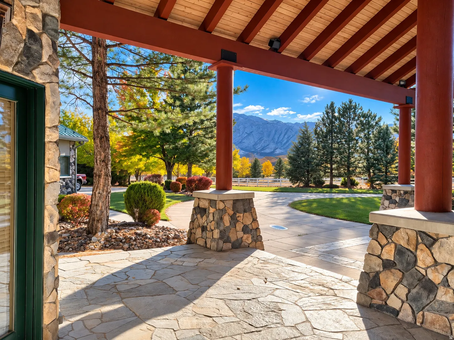 Stone veneer columns supporting a wood-beamed ceiling